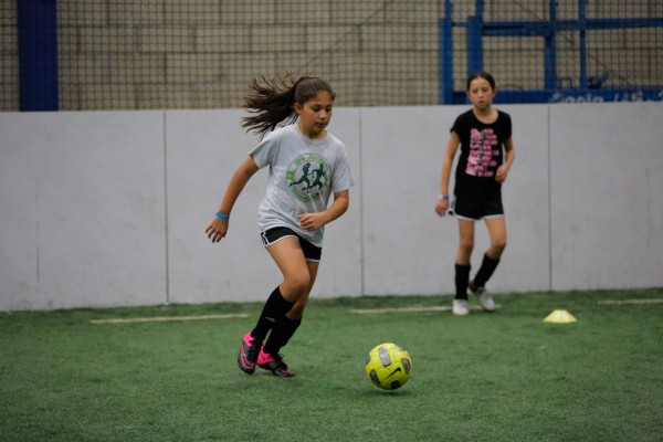 Girl playing indoor soccer at Upland Arena