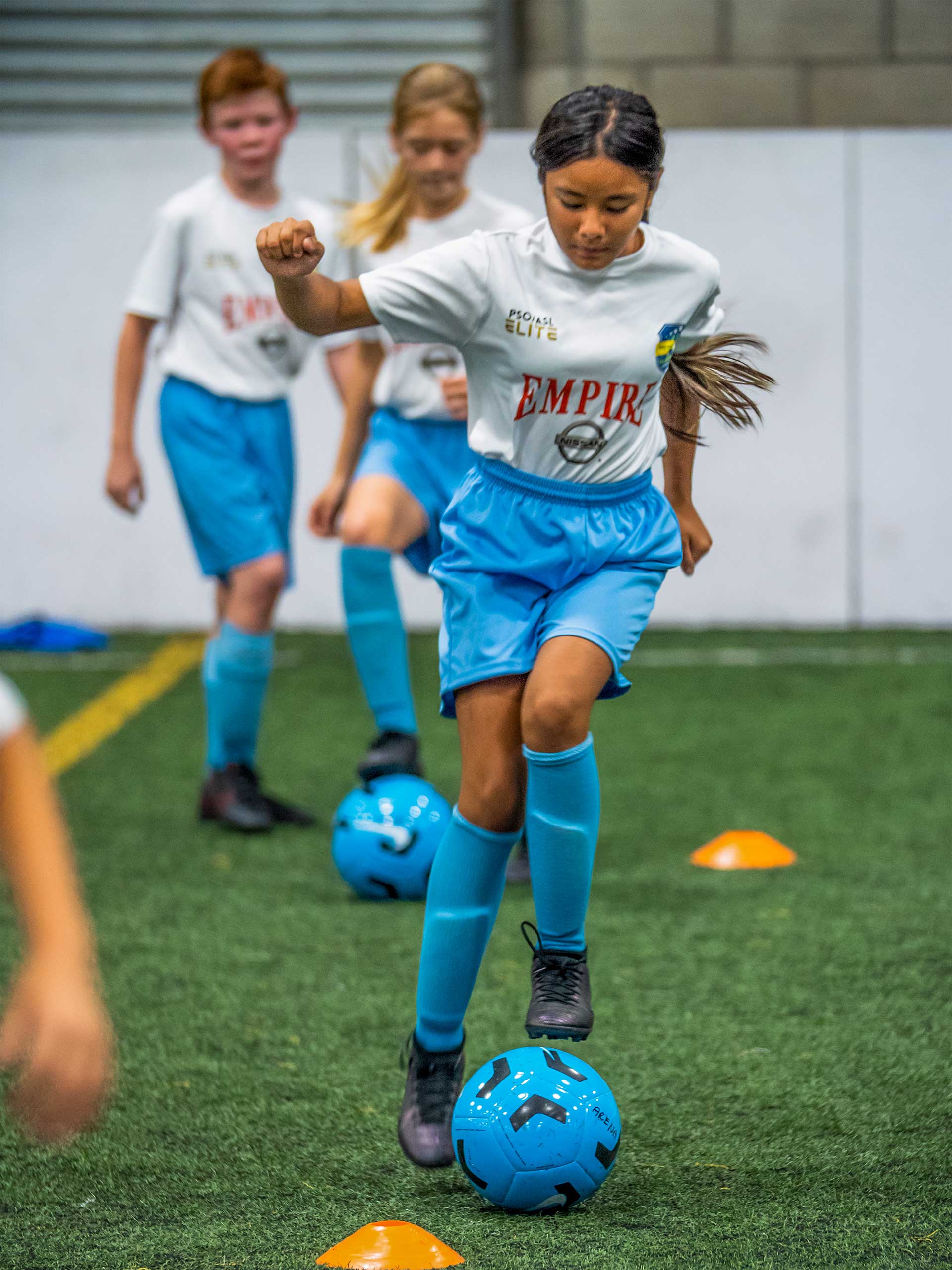two girls using while playing indoor soccer and youth soccer